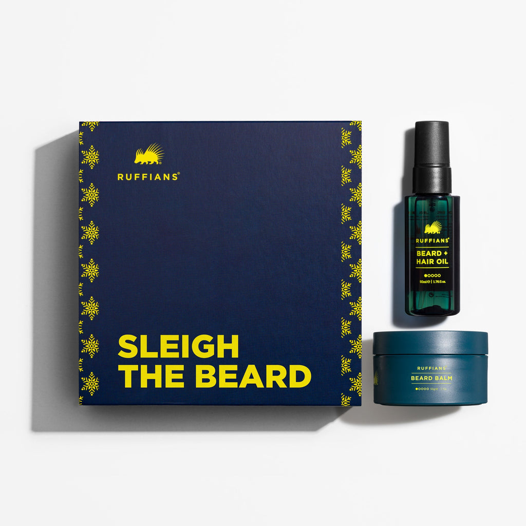 Beard care product set with a dark blue box labeled 'Sleigh the Beard' on a white background.
